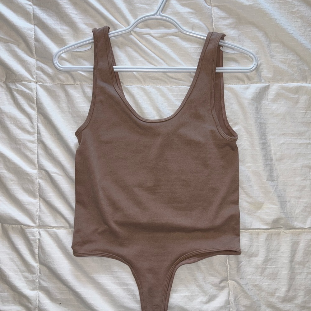 Dusty rose bodysuit
Thong bottom with button closure
Extremely soft material
